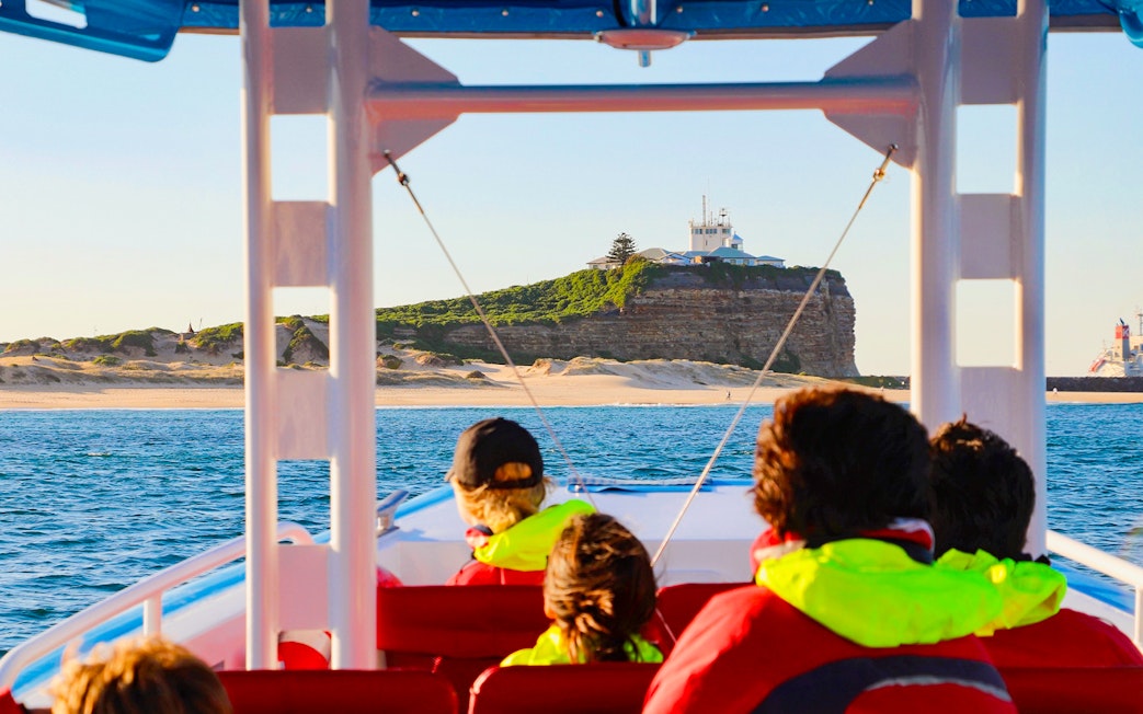 People on a boat during a whale watching tour near Newcastle, Australia.
