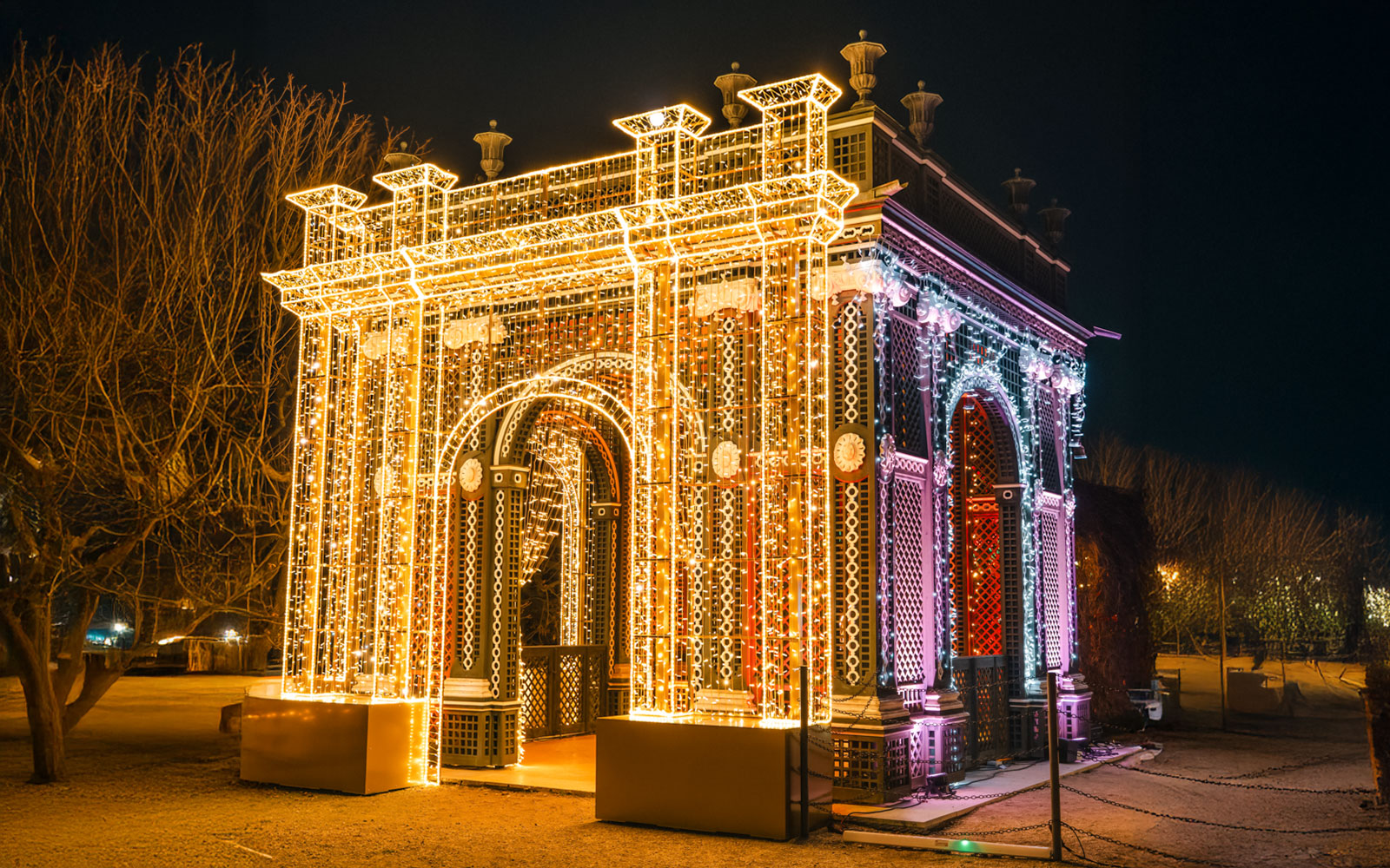 Vienna Christmas light display on an illuminated arch structure at night.