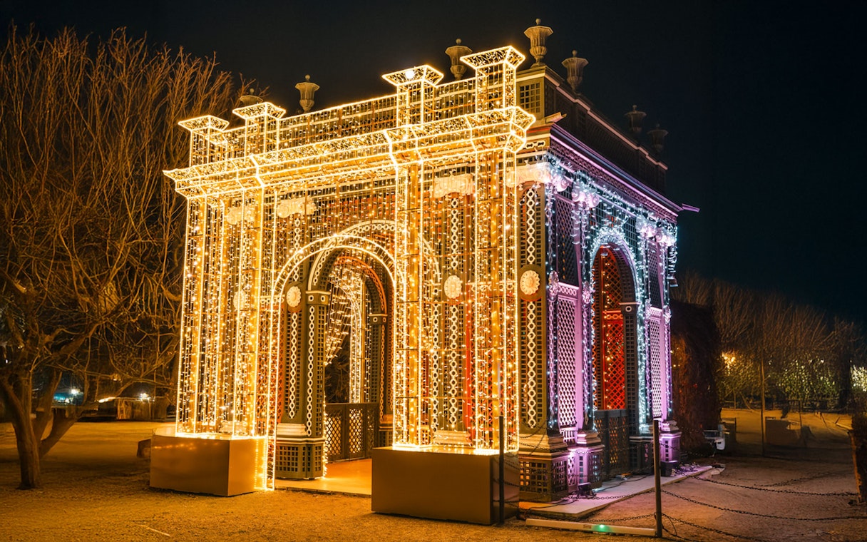Vienna Christmas light display on an illuminated arch structure at night.