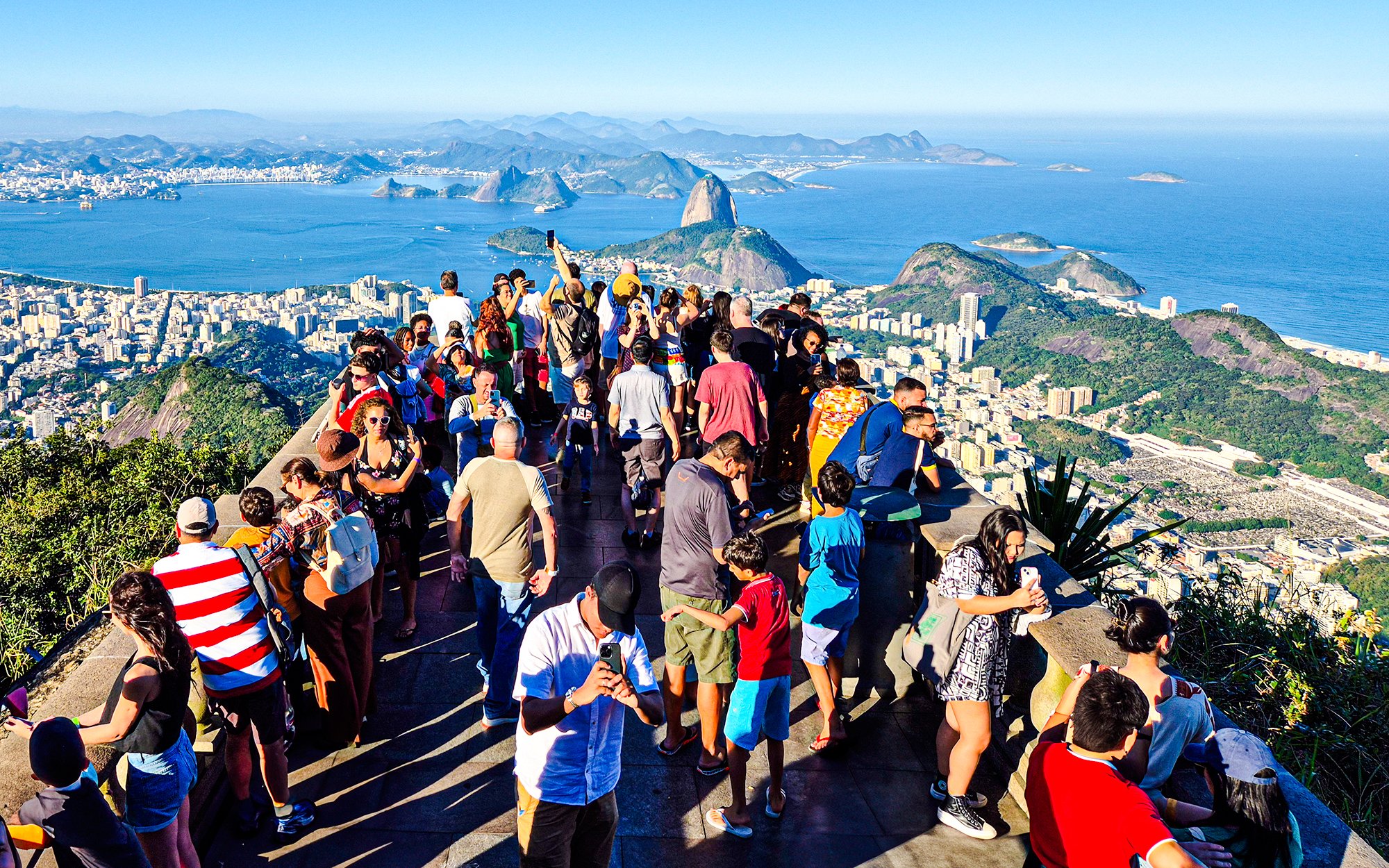 Visitors enjoying the view from Christ the Redeemer viewpoint in Rio de Janeiro.