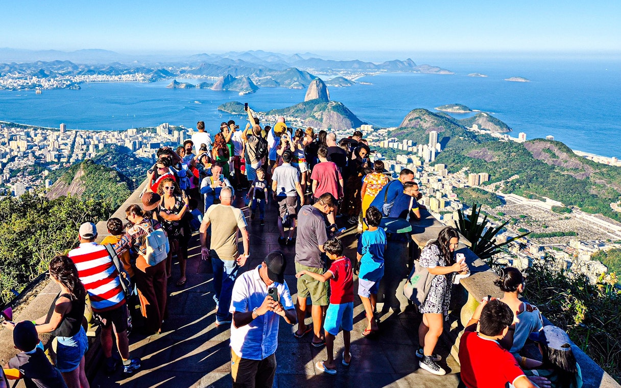 Visitors enjoying the view from Christ the Redeemer viewpoint in Rio de Janeiro.
