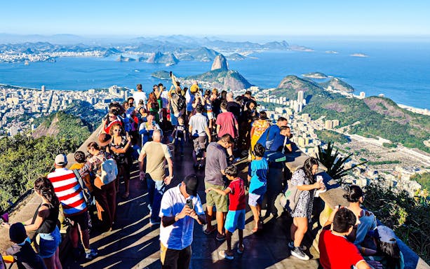 Visitors enjoying the view from Christ the Redeemer viewpoint in Rio de Janeiro.