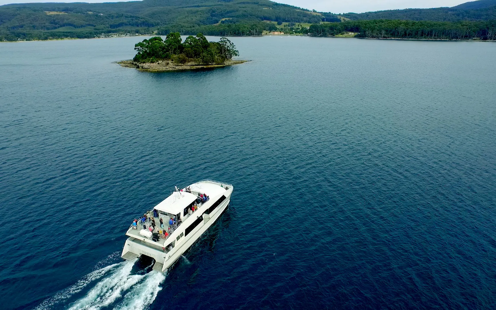 Tour boat cruising near an island on the Tasman Peninsula, Port Arthur.