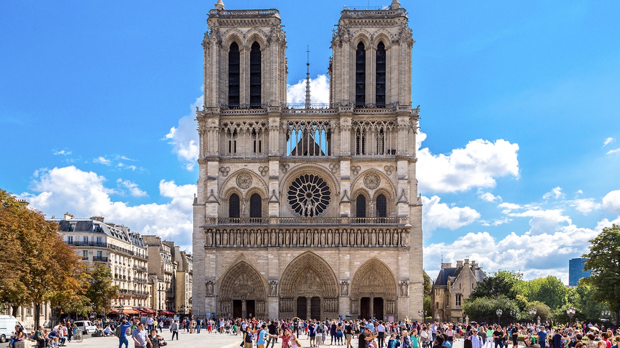Notre Dame Cathedral exterior with a group of tourists on a walking tour in Paris.