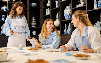 Guests painting tiles at a Traditional Dutch Blue Tile Painting Workshop.