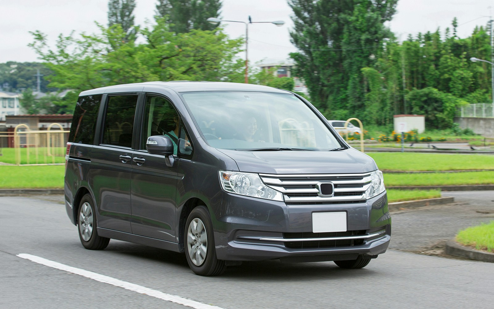 Minivan on a road for AC car transfers.