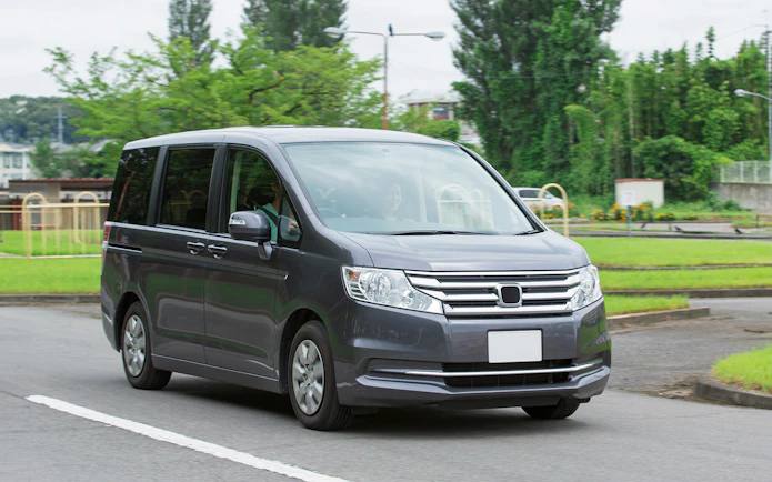 Minivan on a road for AC car transfers.
