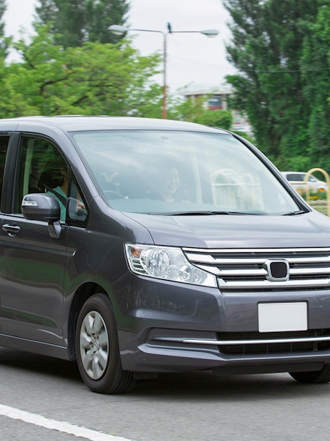 Minivan on a road for AC car transfers.