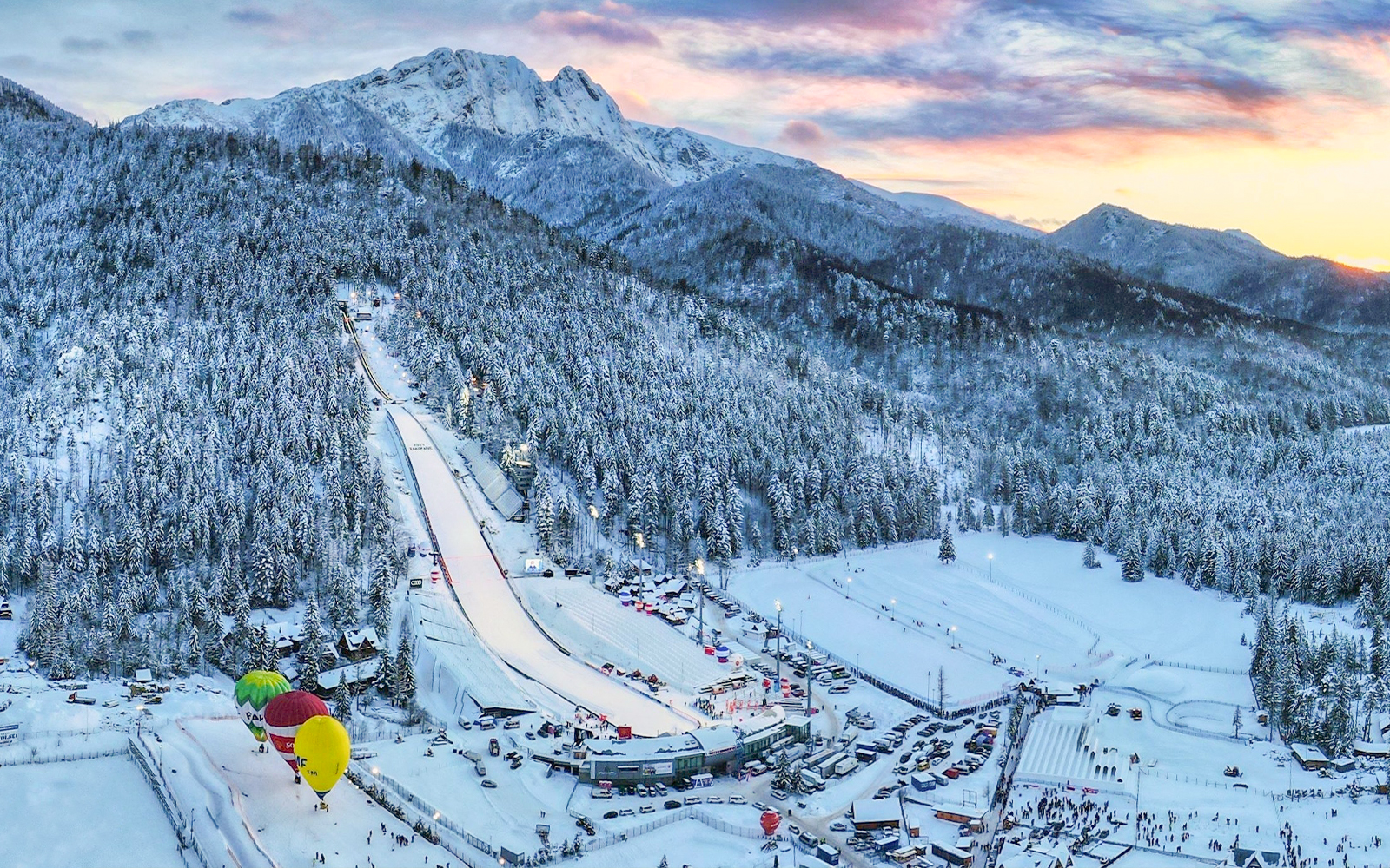 Wielka Krokiew ski jump in Zakopane, Poland, surrounded by snow-covered trees and mountains.