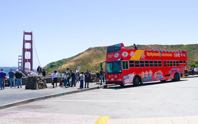 Open-top tour bus near Golden Gate Bridge, San Francisco.