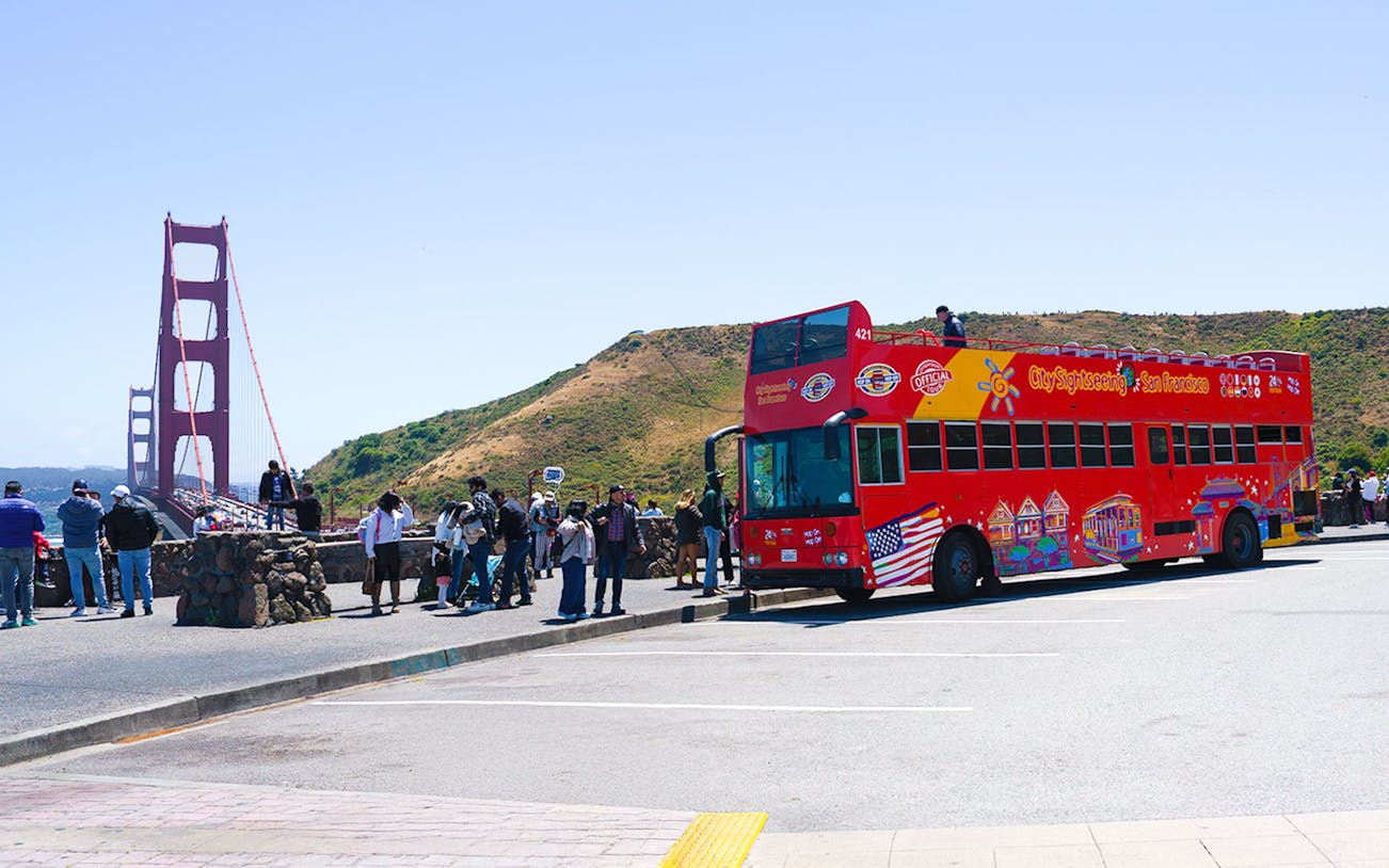 Open-top tour bus near Golden Gate Bridge, San Francisco.