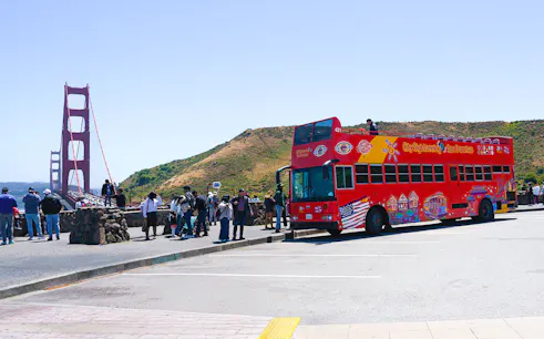 Open-top tour bus near Golden Gate Bridge, San Francisco.