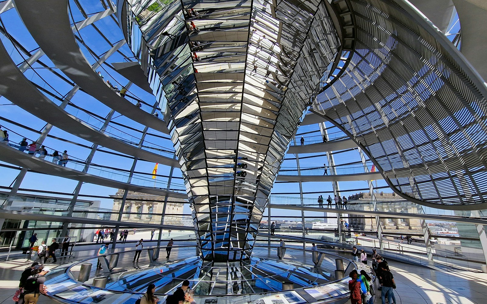 Interior view of the Reichstag dome in Berlin, showcasing the spiral walkway and glass structure.