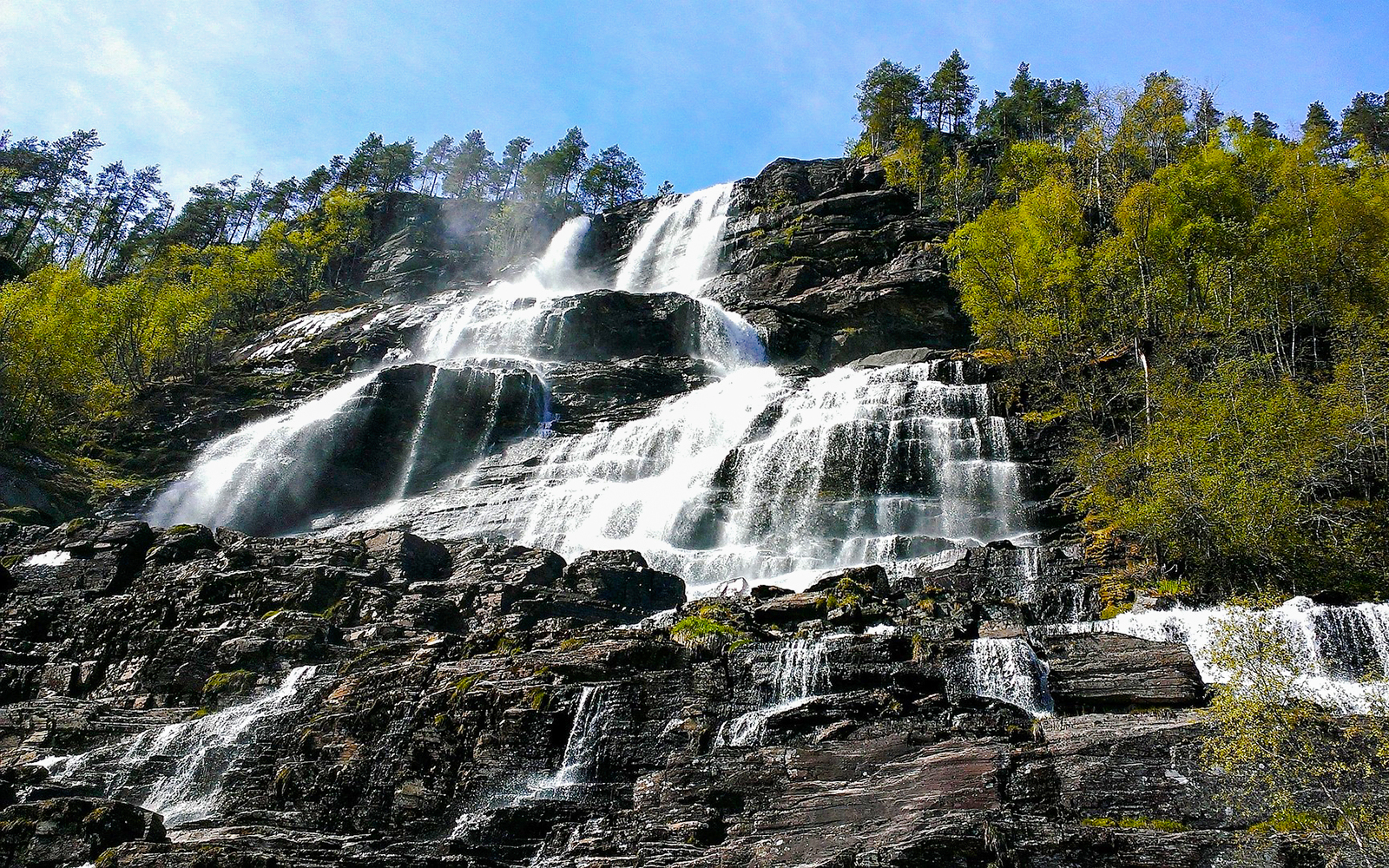 Tvindefossen waterfall cascading over rocky cliffs in Western Norway.