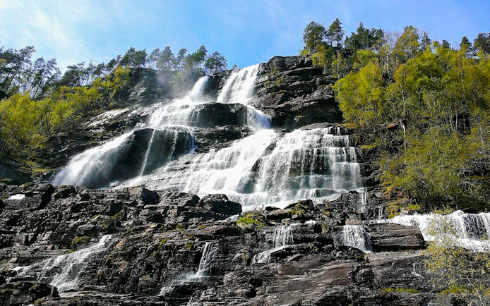 Tvindefossen waterfall cascading over rocky cliffs in Western Norway.