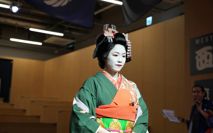Geisha in traditional attire at Kyoto Sumo Entertainment Show.