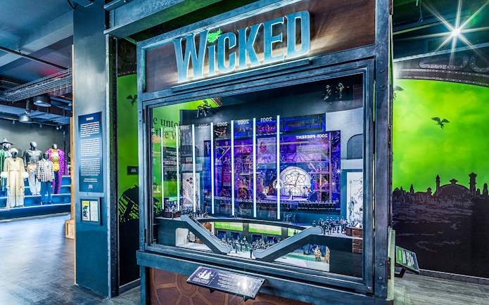 Wicked exhibit at the Museum of Broadway featuring costumes and stage model.
