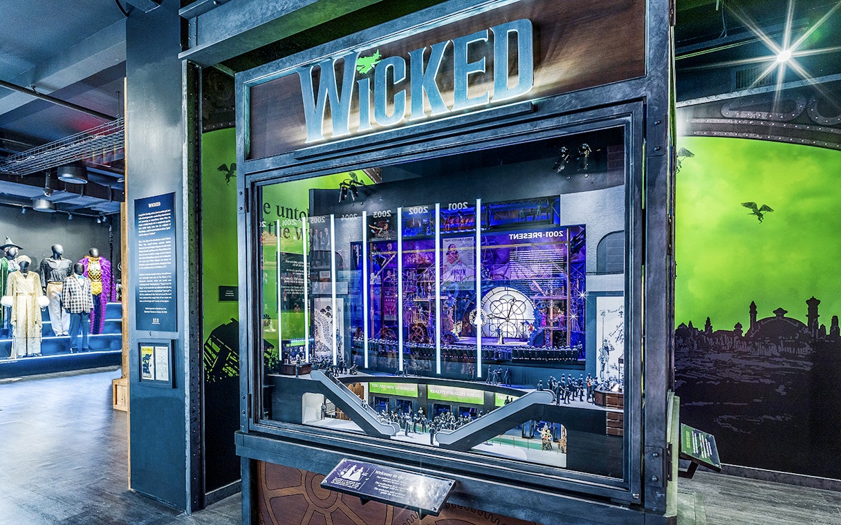 Wicked exhibit at the Museum of Broadway featuring costumes and stage model.