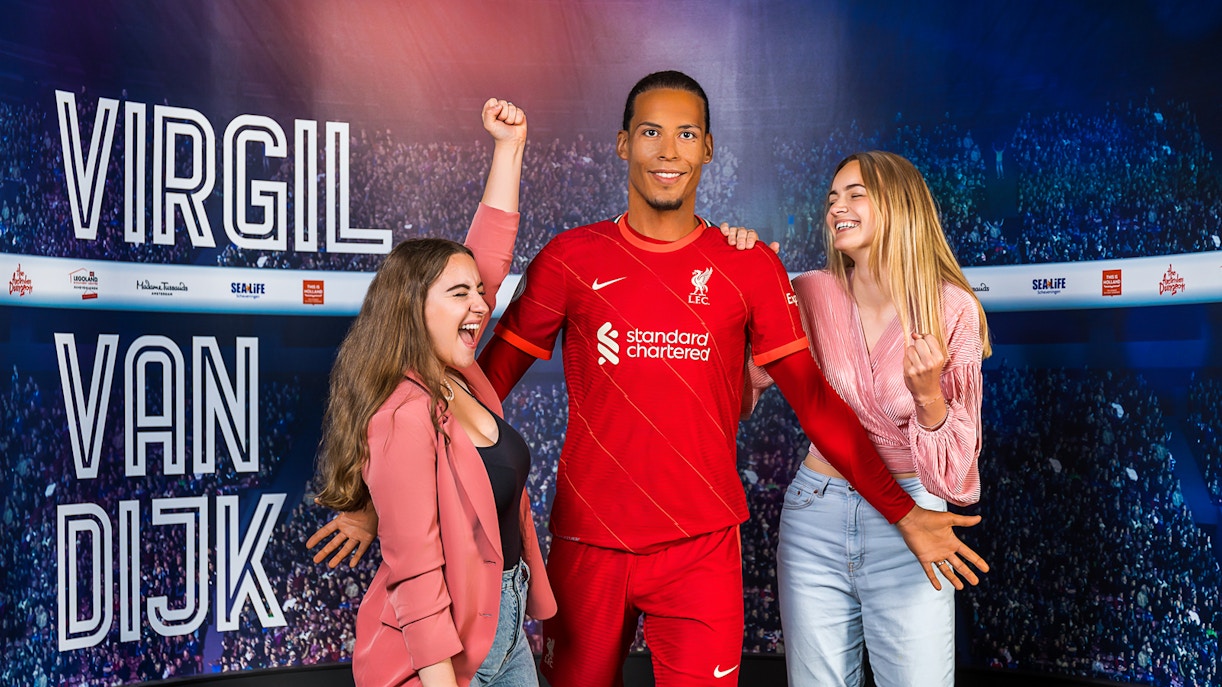 Wax figure of Virgil Van Dijk with visitors at Madame Tussauds Amsterdam.