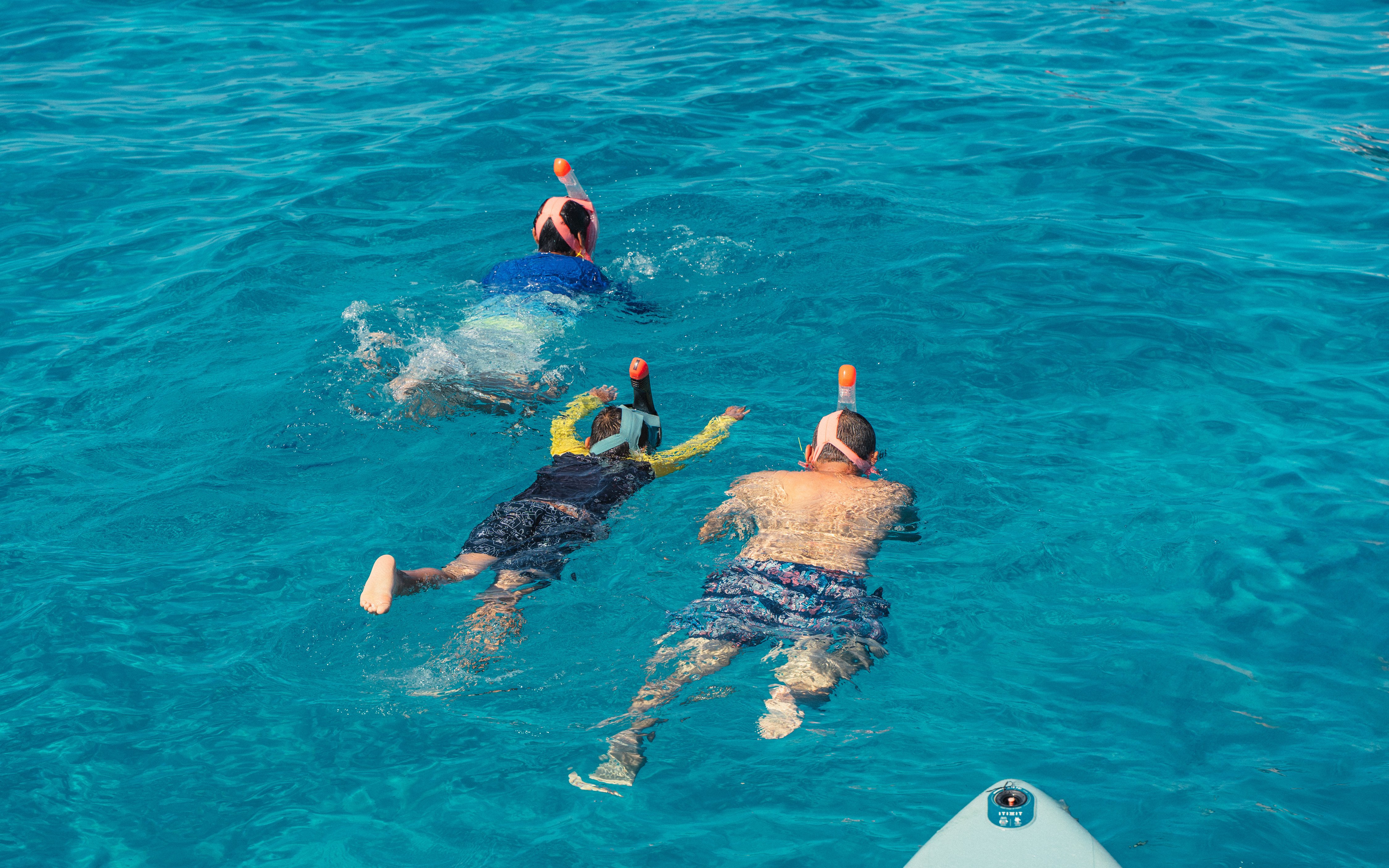 Snorkelers exploring clear waters at Cala Bassa beach, Ibiza, Spain.