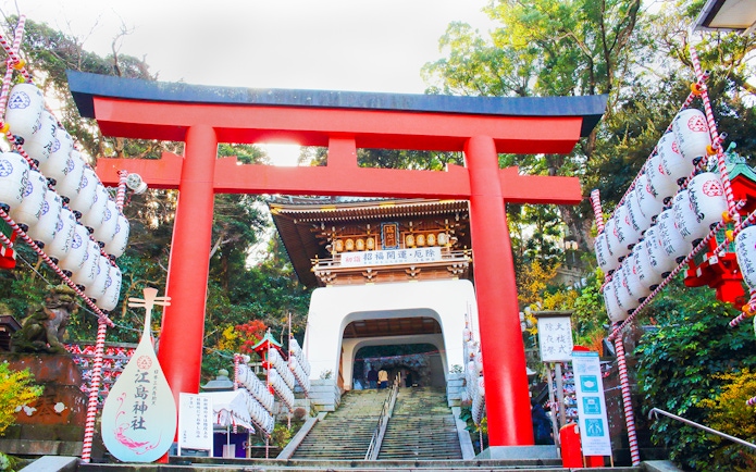 Enoshima Shrine Torii Gate with lanterns and steps leading to the shrine entrance.