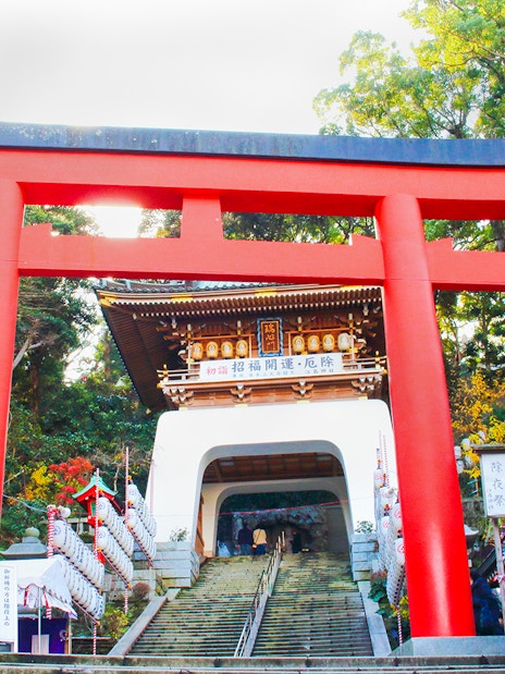 Enoshima Shrine Torii Gate with lanterns and steps leading to the shrine entrance.