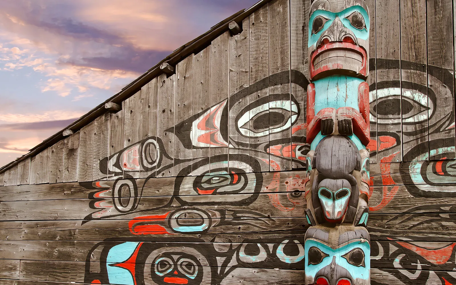 Totem pole and mural at a cultural site in Fairbanks, Alaska.