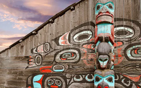 Totem pole and mural at a cultural site in Fairbanks, Alaska.