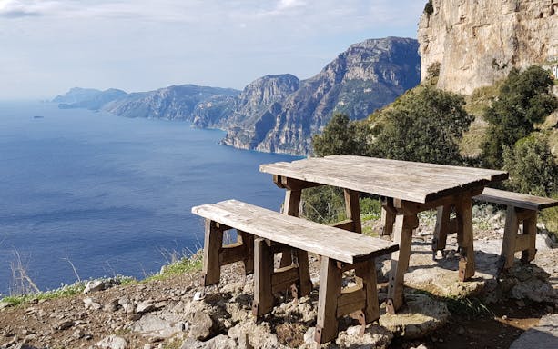 Scenic viewpoint with bench overlooking Amalfi Coast along Path of the Gods, Italy.