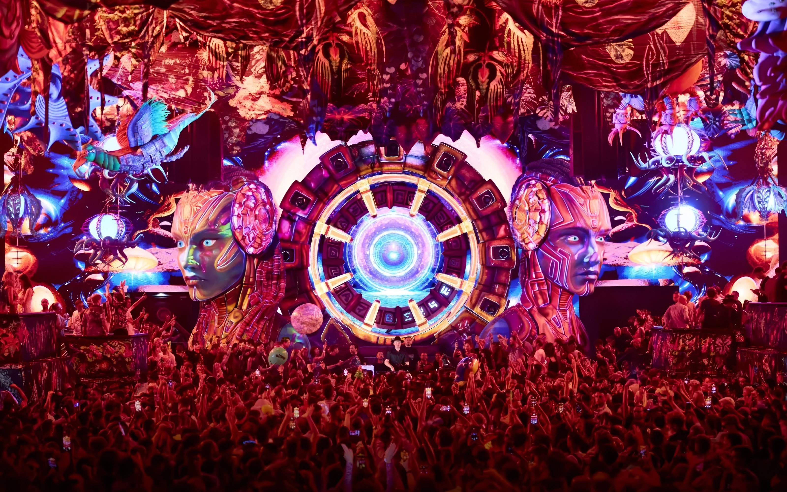 Crowd enjoying vibrant elRow performance with futuristic stage design in Ibiza.