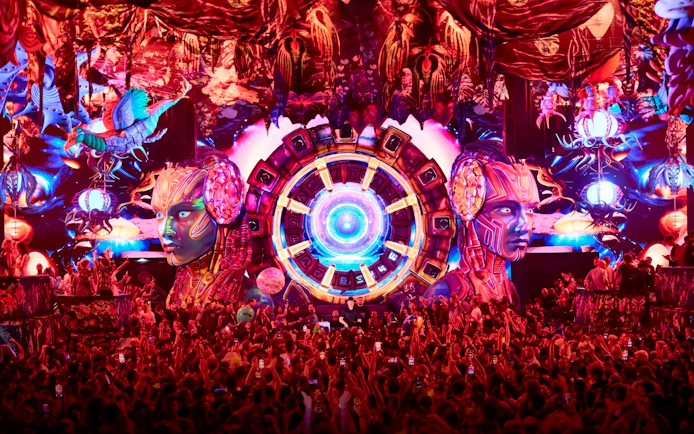Crowd enjoying vibrant elRow performance with futuristic stage design in Ibiza.