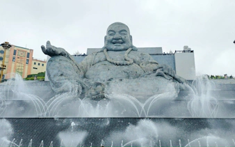 Buddha statue with fountains at Cao Dai Temple, Ho Chi Minh City tour.