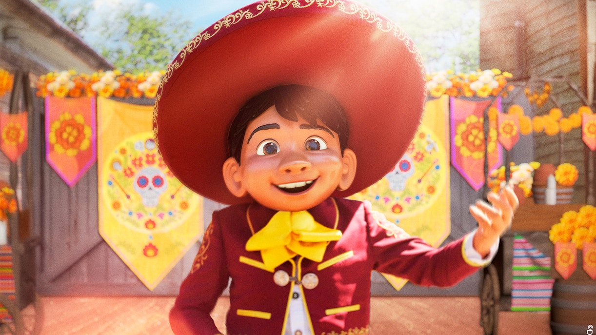 Character in traditional attire at Disneyland Paris with colorful decorations.