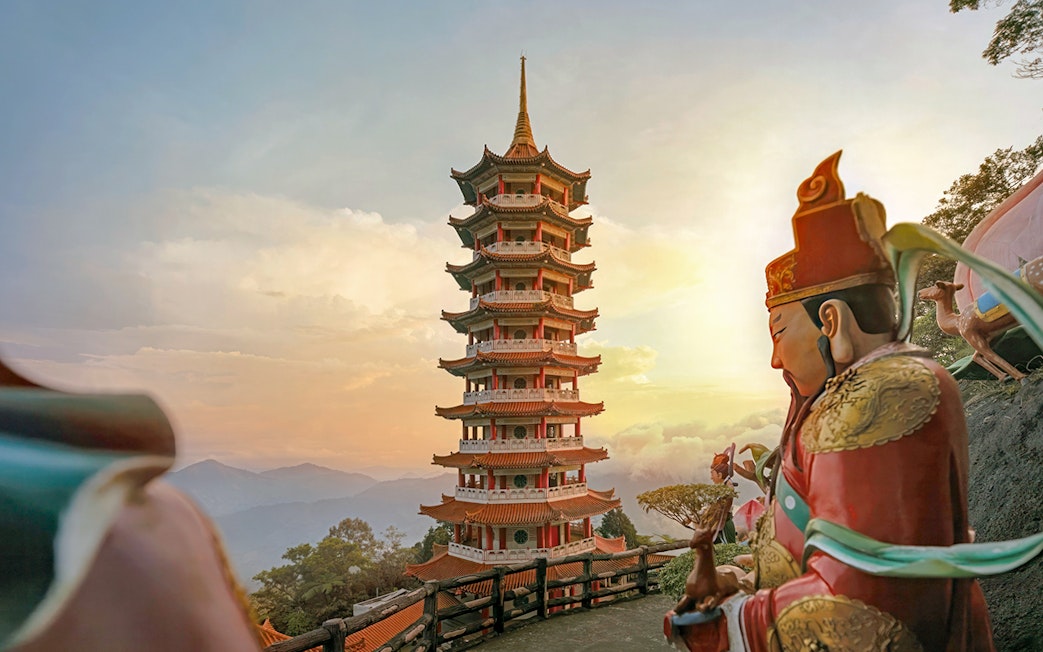 Genting Highlands pagoda and statue at sunset, Malaysia.