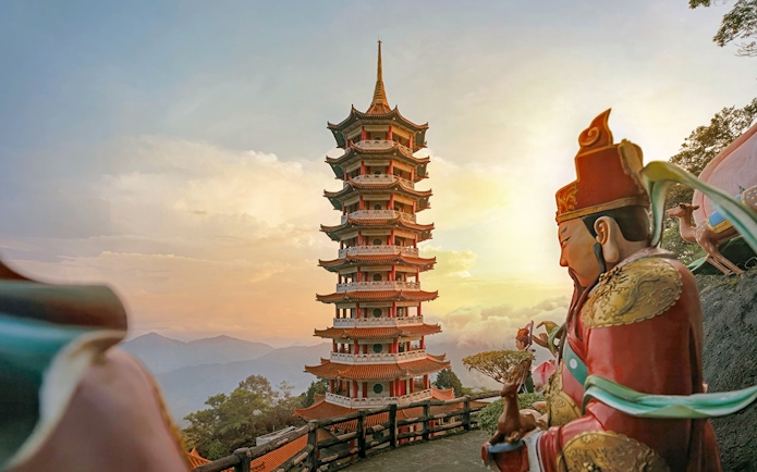 Genting Highlands pagoda and statue at sunset, Malaysia.