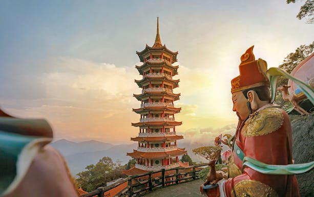 Genting Highlands pagoda and statue at sunset, Malaysia.