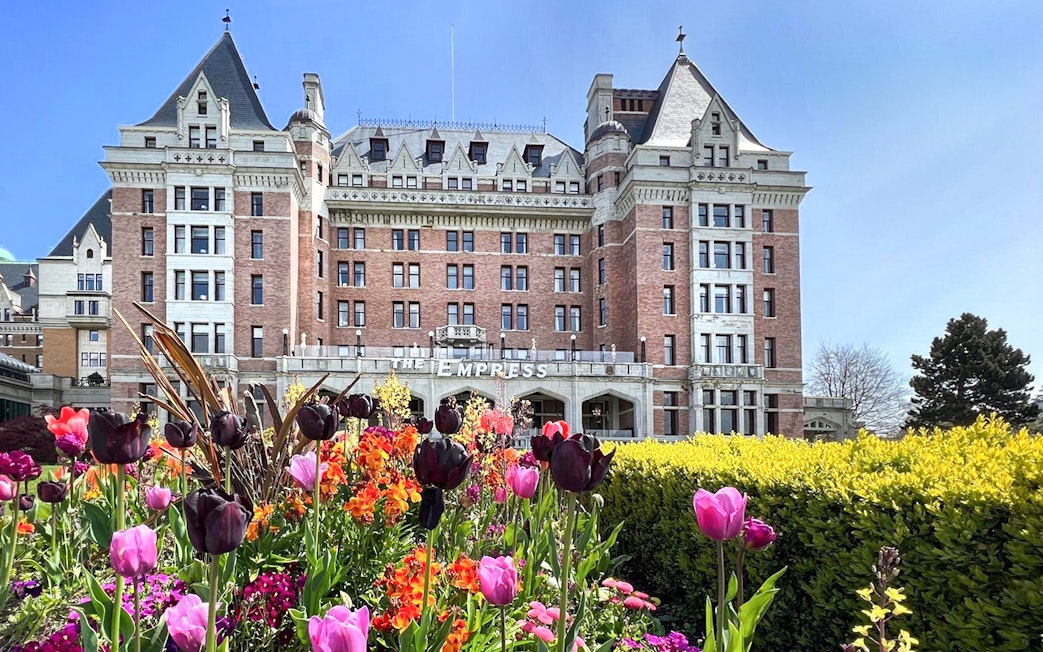 Empress Hotel in Victoria, BC with colorful tulips in the foreground.