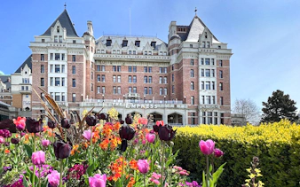 Empress Hotel in Victoria, BC with colorful tulips in the foreground.