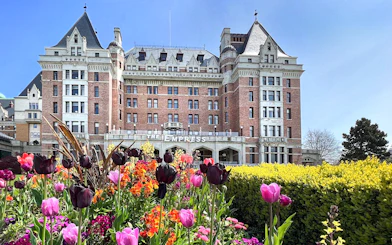 Empress Hotel in Victoria, BC with colorful tulips in the foreground.