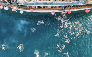 Participants swimming at a boat party in the Blue Lagoon, Split, Croatia.