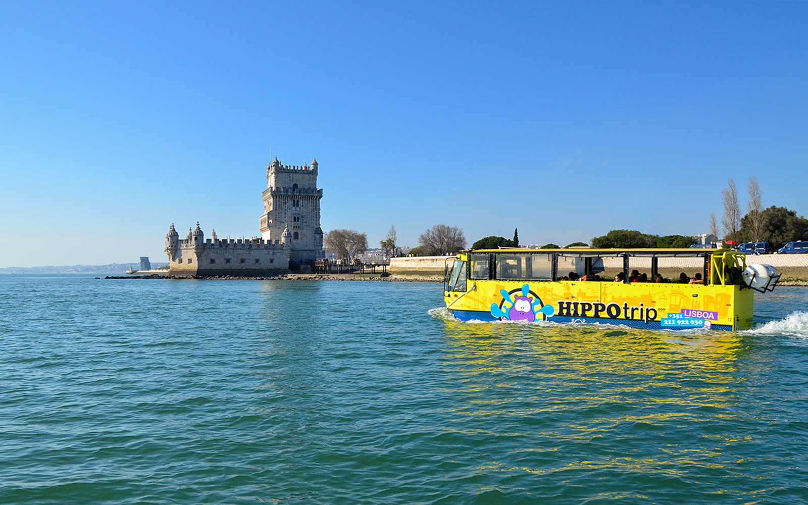 HIPPOtrip vehicle crossing water near Belém Tower, Lisbon.