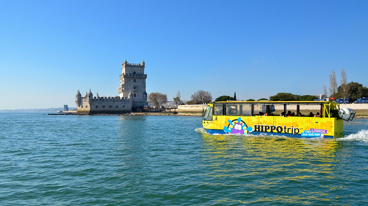 HIPPOtrip vehicle crossing water near Belém Tower, Lisbon.