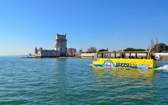 HIPPOtrip vehicle crossing water near Belém Tower, Lisbon.