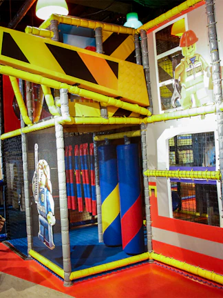 Indoor play area with LEGO-themed construction zone at LEGOLAND Discovery Center.