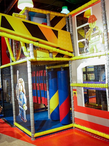Indoor play area with LEGO-themed construction zone at LEGOLAND Discovery Center.