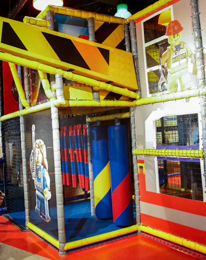 Indoor play area with LEGO-themed construction zone at LEGOLAND Discovery Center.