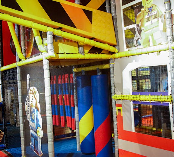 Indoor play area with LEGO-themed construction zone at LEGOLAND Discovery Center.