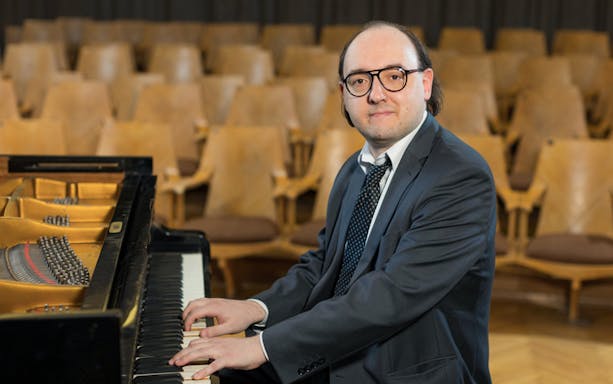 Pianist performing at Chopin Concert in Warsaw Old Town.