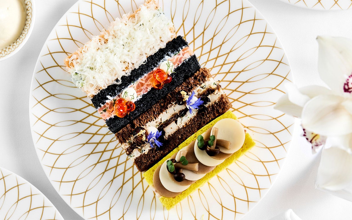 Pastries arranged on a decorative plate at Pearl Afternoon Tea, Platos.