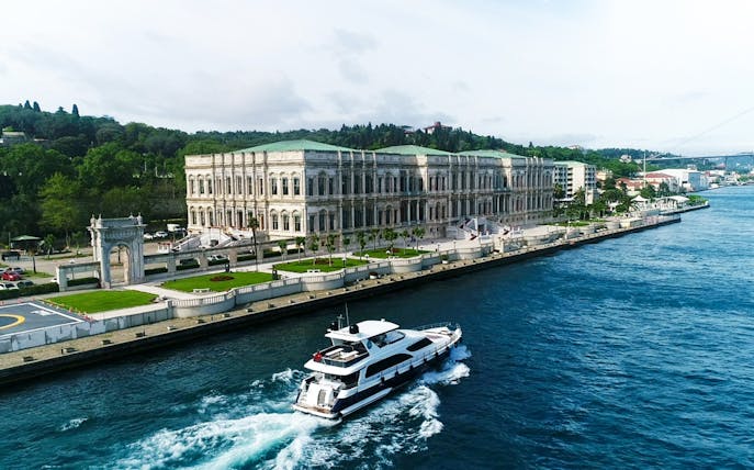 Bosphorus cruise boat passing by the Dolmabahçe Palace in Istanbul.